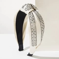 Detailed view of cream satin knotted headband with rows of shimmering grey rhinestones - White