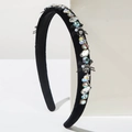 Detail of velvet headband featuring sparkling crystal rhinestones and small black bows - Black