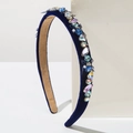 Detailed close-up of dark blue velvet headband with colorful rhinestones and pearls - Blue