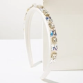 Detail of white padded headband featuring handmade butterfly crystals and square rhinestones - White