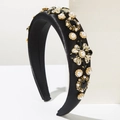 Detailed close-up of a black satin headband featuring pearl and rhinestone floral embellishments - Black