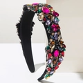 Detail of vintage headband featuring multi-color rhinestones on black velvet fabric - Colorful