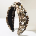 Detail of tartan knotted headband with pearl accents, rhinestones and snowflake patterns - Brown