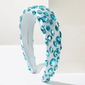 Detail of aqua blue crystal gemstones hand-sewn on a luxury satin padded headband - Blue