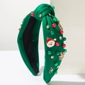 Dettaglio del cerchietto natalizio verde con nodo, perle, strass e Babbo Natale - Verde