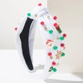 Dettaglio fascia natalizia bianca con ciondoli di Babbo Natale, fiocchi e strass - Bianco