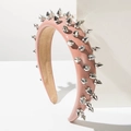 Detail view of pink leather headband featuring silver punk-style metal conical studs - Pink