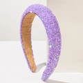 Macro detail of elegant purple headband encrusted with sparkling rhinestones and soft lining - Purple