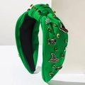 Cerchietto annodato verde con cappelli da mago e strass su supporto bianco - Verde