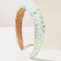 Dettaglio di paillettes colorate a stella e cuore su cerchietto bianco con fodera scamosciata - Verde