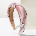 Detail of pink velvet headband featuring sparkling rhinestones and crystal ornaments - Pink