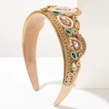 Close-up of Baroque crown headband with champagne crystals and intricate gold metal details - Coffee