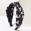 Close-up of the knot detail on a Halloween fabric headband with ghost and spider web prints - Spider Web Ghost