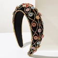 Macro shot of colorful rhinestones on a luxury velvet headband for festive banquets - Colorful