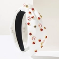 Detail of white knotted baseball headband with rhinestones and enamel charms - White