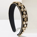 Detailed view of luxury velvet baroque headband with sparkling crystals and gold settings - White