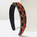 Macro side view of baroque velvet headband with red crystals and golden metal claw settings - Red