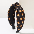 Halloween knot headband featuring a festive candy corn print on a black fabric background - Candy