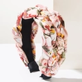Close-up of a wide braided headband with pink floral fabric and a non-slip lining - Pink Multi