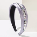 Detail view of purple satin headband with sparkling rhinestones and white pearls - Purple