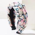 Detailed view of woven braided floral headband with colorful pattern and non-slip lining - Blue Gradient