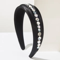Macro view of black velvet headband with white pearls and sparkling rhinestone details - Black
