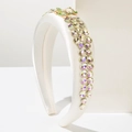 Detail of satin headband featuring gradient rhinestones and a gold bee ornament - White
