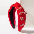 Dettaglio del cerchietto rosso a coste con nodo, cuori decorativi e strass lucidi - Cuore in Zircone Rosso