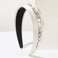 Elegant champagne satin headband with pearls and rhinestones on geometric display stand - White