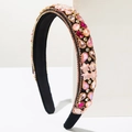 Close-up of pink crystal stars and rhinestones on luxury black velvet headband - Pink