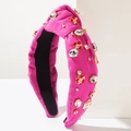 Detail of rose pink knotted headband with crystal rhinestones and Love heart charms - Rose Gold