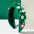 Gros plan d'un serre-tête vert à nœud avec flocons de Noël et perles décoratives - Vert