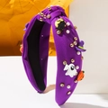 Detail of purple knotted Halloween headband with rhinestones, pearls and festive charms - Purple