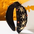 Serre-tête gothique d'araignée avec strass rouges et accents dorés sur fond de toile d'araignée - Noir