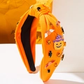 Knotted Halloween headband in orange knit featuring festive pumpkin and bat diamond charms - Orange