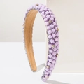 Close-up of a luxury purple floral headband with crystal rhinestones on a white stand - Purple
