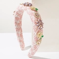 Close-up of pink and white tweed headband with purple crystals and enamel daisy flowers - Pink