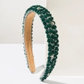 Detail of dark green resin roses and sparkling crystals on a baroque floral headband - Green