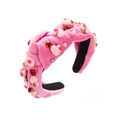 Detail of pink velvet headband featuring red heart gems, faux pearls and floral accents - Pink Heart