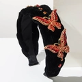 Detalle de diadema de terciopelo negro con lujosas mariposas de cristal rojo incrustadas - Rojo