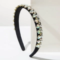 Detailed side view of black velvet headband with sparkling crystal hearts and pearls - AB Zircon