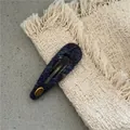 Close-up of navy blue knit BB hair clip with a golden Hand Made metal logo plate - Knitted Teardrop Style (J8.2/300-B263) / Navy Blue