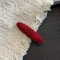 Detailed view of red velvet oval hair clip showing high-quality flocked texture and finish - B5.2 Red Plaid Pointed Oval (Duckbill Clip)