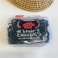 Detalle de gomas de pelo negras de alta elasticidad en una caja transparente para niños - Negro Hormiga