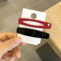 Minimalist red and black geometric plastic hair clips set on a white display card - Black + Red
