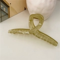 Close-up of olive green jelly hair claw clip with crossed design and metal spring - Green (Jelly)