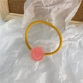 Élastique à cheveux jaune avec breloque smiley 3D rose en résine sur papier blanc - Visage Souriant Rose Orangé