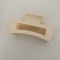 Detail view of a matte cream rectangular hair claw clip with geometric hollow design - Matte Off-white (C3.5)