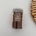 Detail of high-elasticity dark brown seamless hair ties in a clear storage jar - Brown