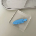 Close-up of matte light blue seamless hair clip with debossed branding on a clean background - Sky Blue